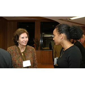 Melanie Arvajo converses with a woman at the Torch Scholars dinner