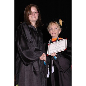 Dean Carole Kenner presents Kelly Gallant with an award at the School of Nursing convocation ceremony