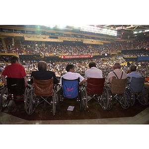 Guests in wheelchairs watch the commencement ceremony