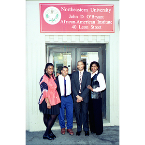 Four faculty members standing in front of the John D. O'Bryant African American Institute