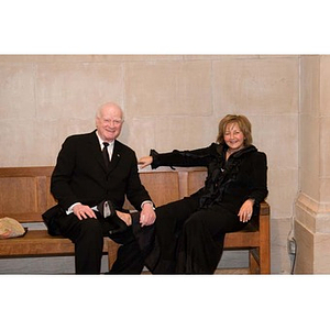 A couple sits on a bench at the Museum of Fine Arts for President Aoun's inauguration celebration