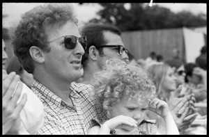 Father and infant daughter in the audience, waiting to see Taj Mahal in concert, Newport Folk Festival