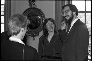 Russell A. Hulse (right) and wife (?), talking at a reception with Massachusetts state legislators honoring his Nobel Prize in Physics