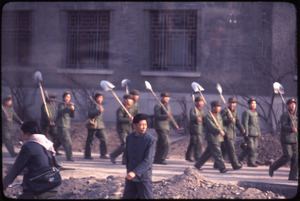PLA soldiers with shovels on their shoulders