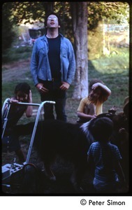 Unidentified man with children, dog, and lawn mower, Tree Frog Farm commune