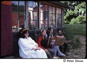 Musicians seated by the house, waiting to perform, Tree Frog Farm commune