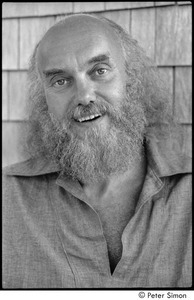 Ram Dass at typewriter: Portrait of Ram Dass smiling