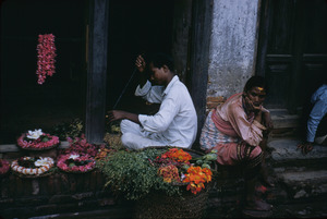 A flower seller making petal wreaths