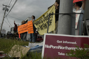 Protest against a pornographic video store in Northampton: protesters with signs reading 'Women's bodies are not for profit' etc.