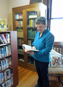 Paige Memorial Library: woman browsing in the reading area