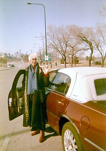 A Photograph of Marlow Monique Dickson in front of a Car