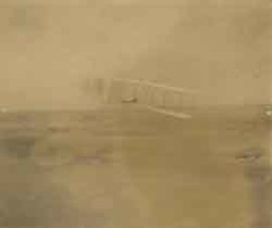One of the Wright brothers (unidentified) flying the Wright 1903 glider, Outer Banks, North Carolina