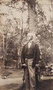 Robert W. Hooper standing outdoors with tree