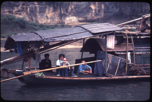 Rear of houseboat, another boat, child, family