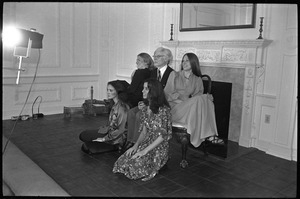 Andy Warhol posed in front of a fireplace, surrounded by four women, during a reception at the Birmingham Museum of Art