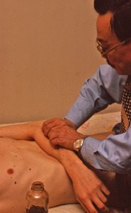 Dr. Garland Song treating a patient