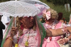 Parade marcher in pink with a lacy parasol : Provincetown Carnival parade