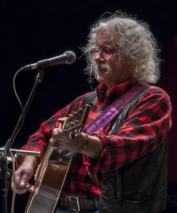 Arlo Guthrie (guitar) performing at Symphony Space, New York City, in a concert to pay tribute to George Wein