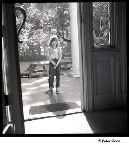Carly Simon standing outside a door