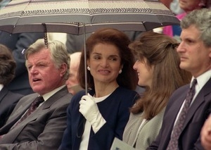 Jackie Kennedy Onassis (under umbrella) with Caroline Kennedy and Edward Kennedy at dedication of the John F. Kennedy statue at the Massachusetts Statehouse