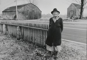 Elizabeth Phillips who lives off Rte. 44 in Glocester: Phillips standing by a fence on her property with barn and outbuilding in background