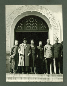 W. E. B. Du Bois, Shirley Graham Du Bois, and Chinese dignitaries in front of a building in China