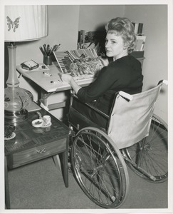 Mrs. Frances Marsala seated in her wheelchair doing artwork