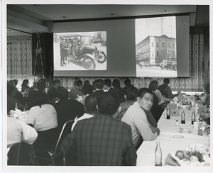 Attendees watching presentation at Thanksgiving celebration