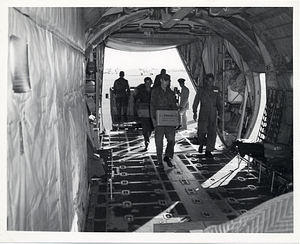 Members of the United States Air Force load cargo