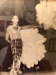 A Photograph of Marlow Monique Dickson Posing with Feather Fans