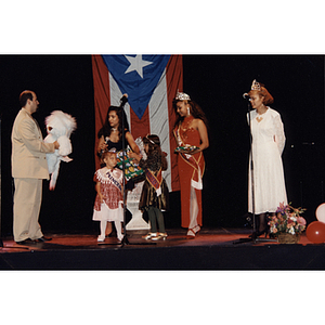 Several people stand on stage at the Festival Puertorriqueño