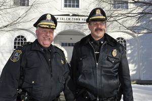 Two New Salem town police officers standing in front of the old Town Hall building