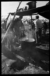 Preparing a communal meal under a makeshift shelter, Earth People's Park