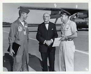 Mark Bortman and U.S. Air Force personnel in front of an airplane