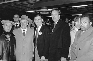 Mayor Raymond L. Flynn wearing a New England Patriots button and posing with Boston City Councilor Bruce Bolling and others