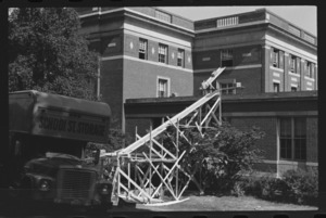 Photographs of books being moved from Converse Hall to Robert Frost Library, 1965 July 14