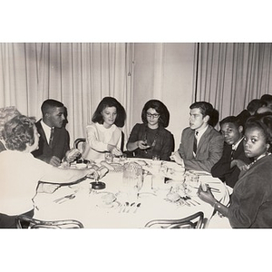 An unknown group of individuals seated around a dining table