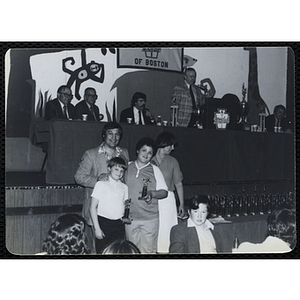 A man posing with two boys holding their awards during a Boys' Clubs of Boston Awards Night