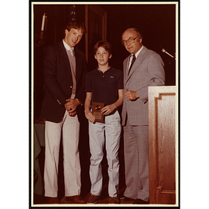 Mario Fabiano receives an award from Robert Cleary, Overseer of the Boys' Clubs of Boston, at right, and an unidentified man