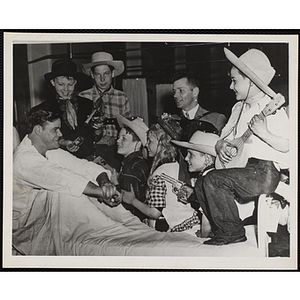 The Bunker Hillbillies visit an unidentified man in a hospital bed