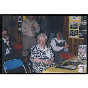 An elderly woman receives applause at a Bunker Hillbilly alumni reunion event