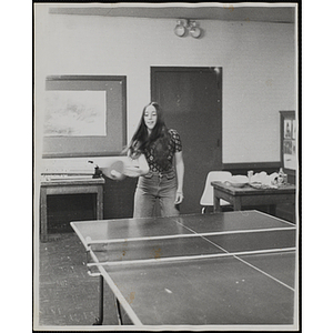 A teenage girl plays table tennis