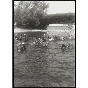 A group of youth gathered in the water during a swimming activity