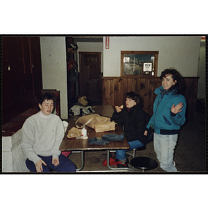 Three teenage girls pose for a shot in a ski lodge