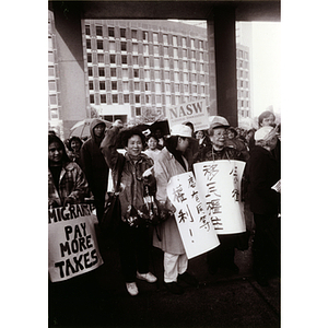 Asian Americans participate in a demonstration in Boston for immigrant rights