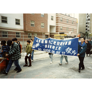 People marching a victory banner through Chinatown