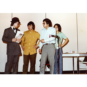 Three men and a woman performing a theatrical sketch onstage at the Josiah Quincy School about the normalization of U.S. and China relations