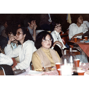 Men and women eating dinner during a Chinese Progressive Association event