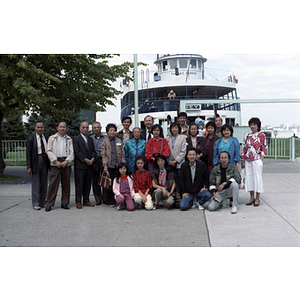 Chinese Progressive Association members pose together in front of a ferry on their trip to Toronto