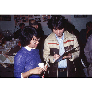 During an International Women's Day celebration dinner, a young man talks to Suzanne Lee